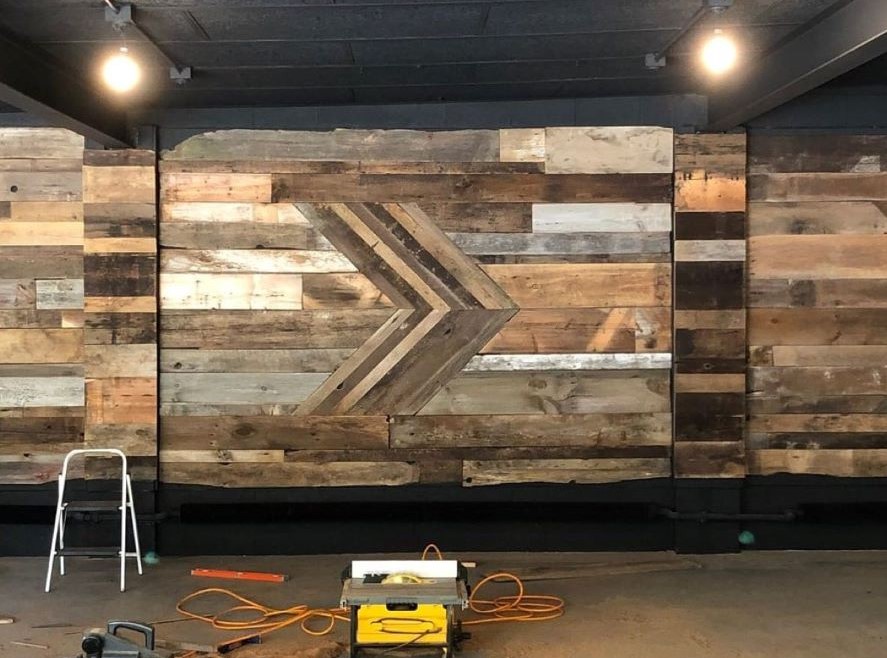 The custom designed reclaimed barnwood accent wall, created for and installed in the White Buffalo Yoga Studio
