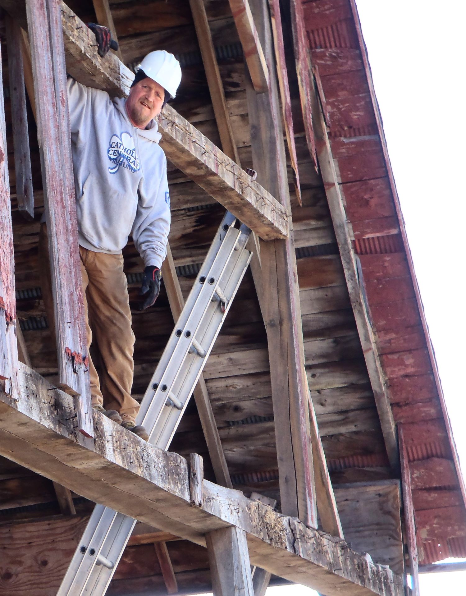 Jim standing on the belly beam of 200 year old barn