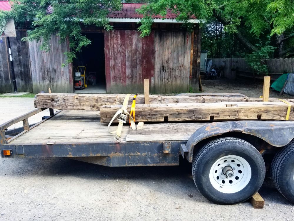 Reclaimed barn beams on a trailer so they're ready for a delivery