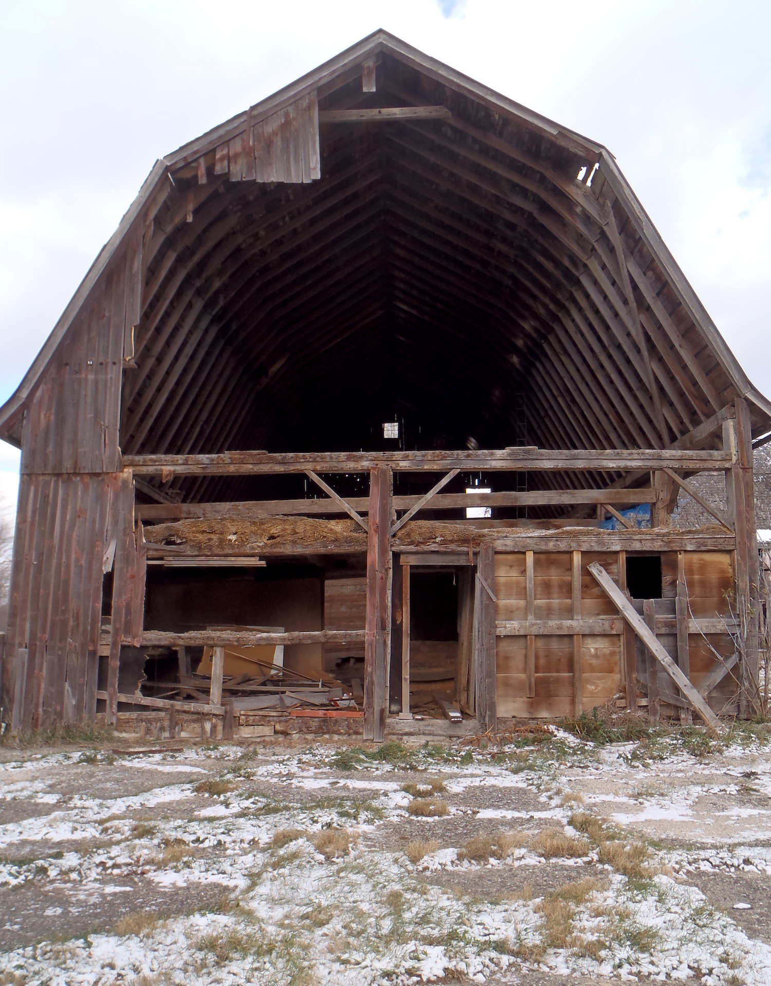 A partially dilapidated barn that is over 100 years old