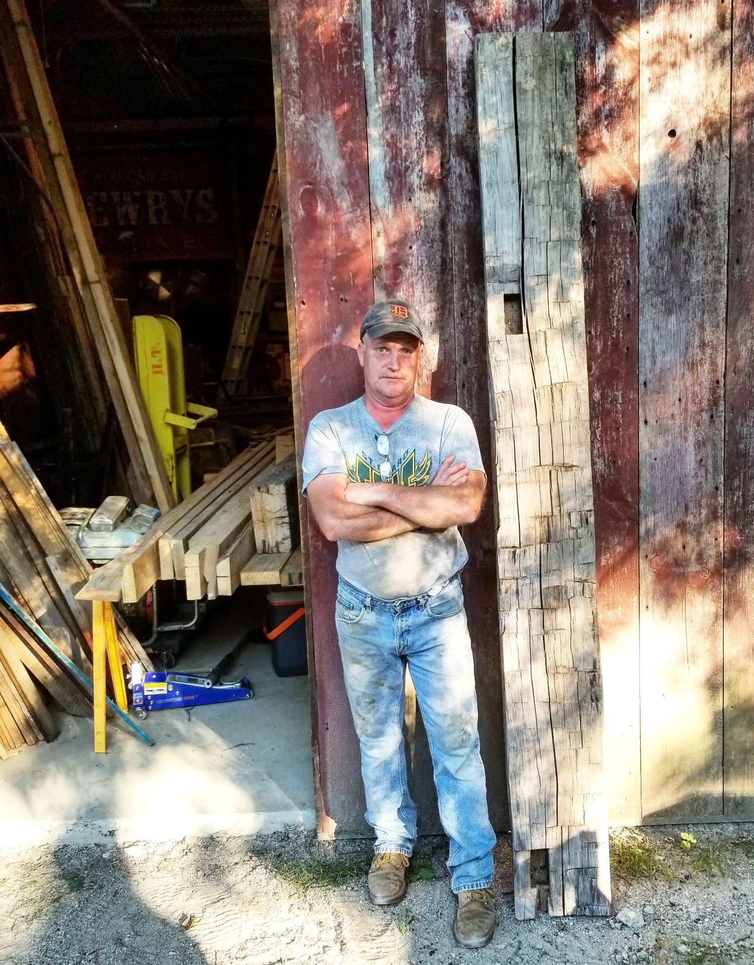 Michigan Reclaimed Barns and Lumber owner standing infront of his workshop