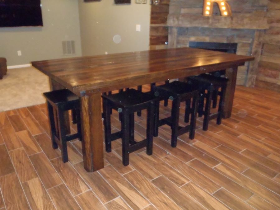 A reclcaimed barnwood table surrounded by chairs in a customer's dining room