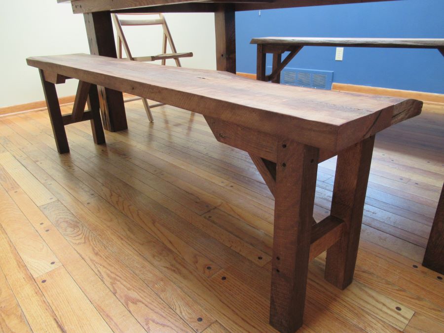 A custom designed, reclaimed barnwood viking table and bench