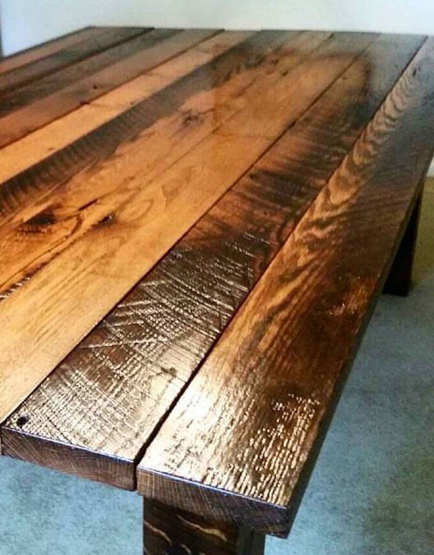 A close up of a Michigan Reclaimed Barns and Lumber viking table