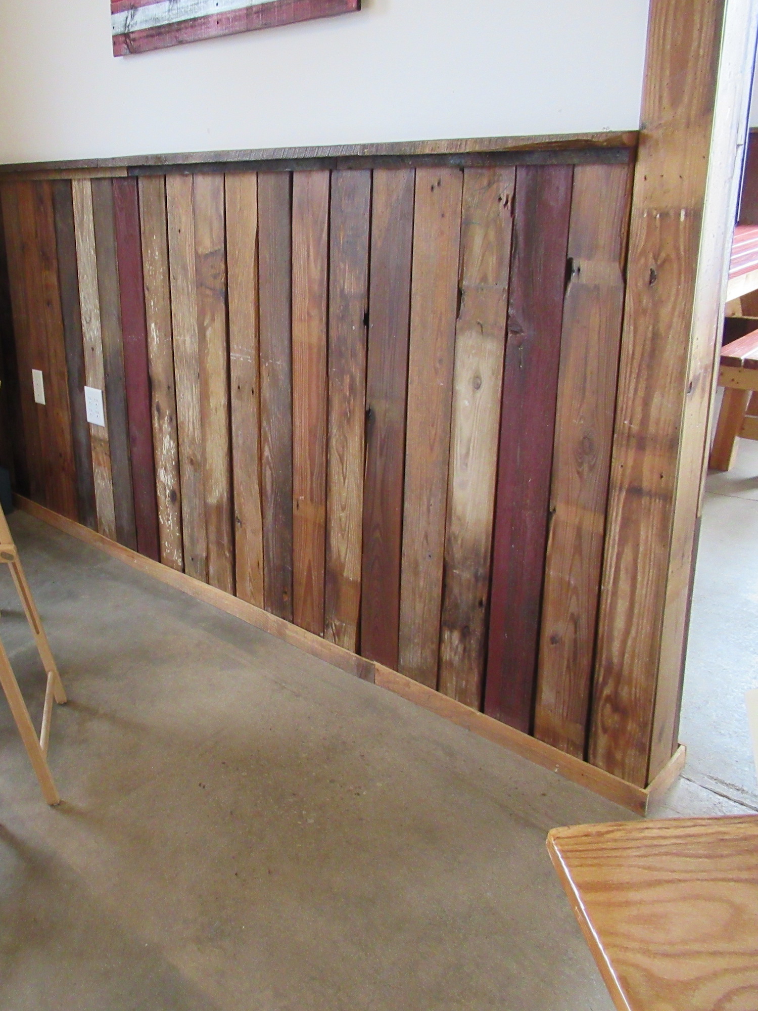 A red and brown accent wall made from reclaimed lumber