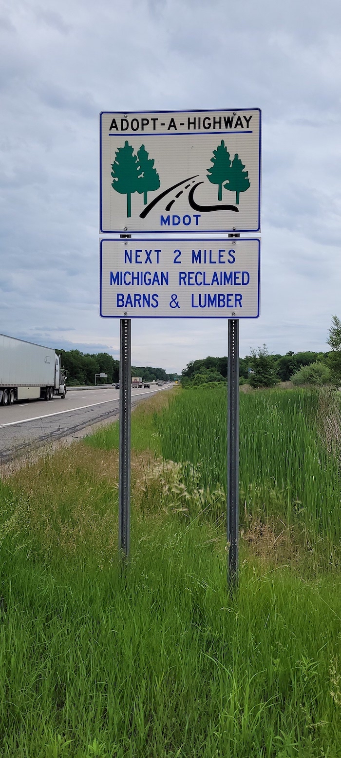 The Michigan Reclaimed Barns and Lumber Adopt-A-Highway sign located on I-94