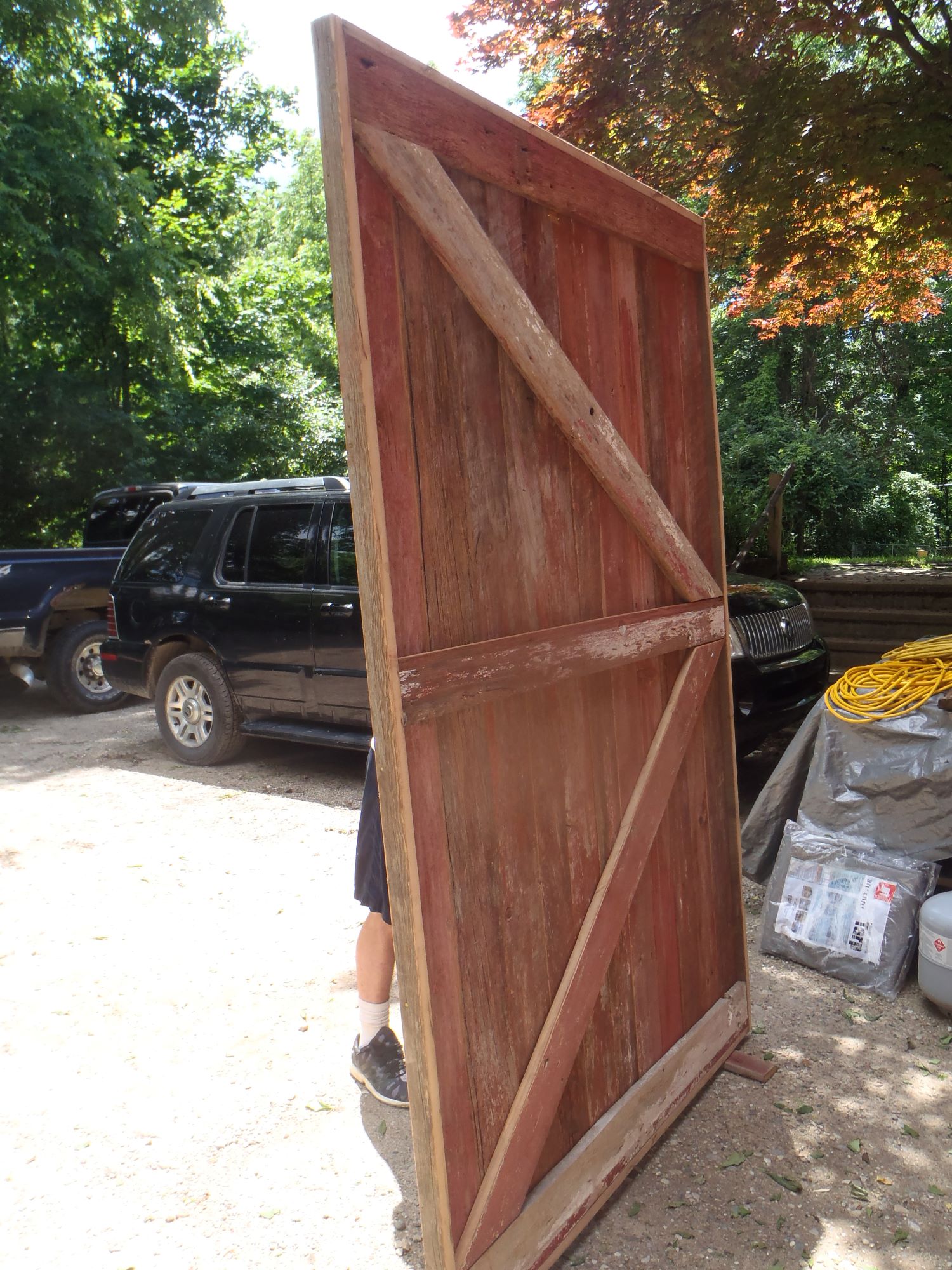A custom sliding door made from repurposed barn wood