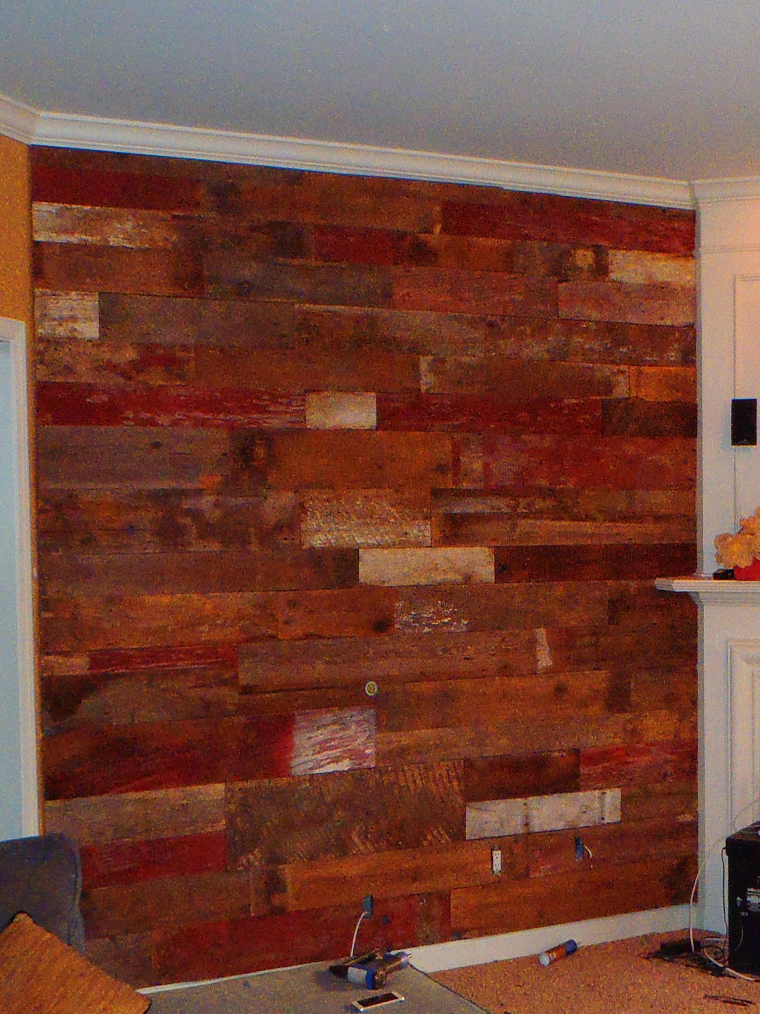 A primarily red barnwood accent wall in a customer's home