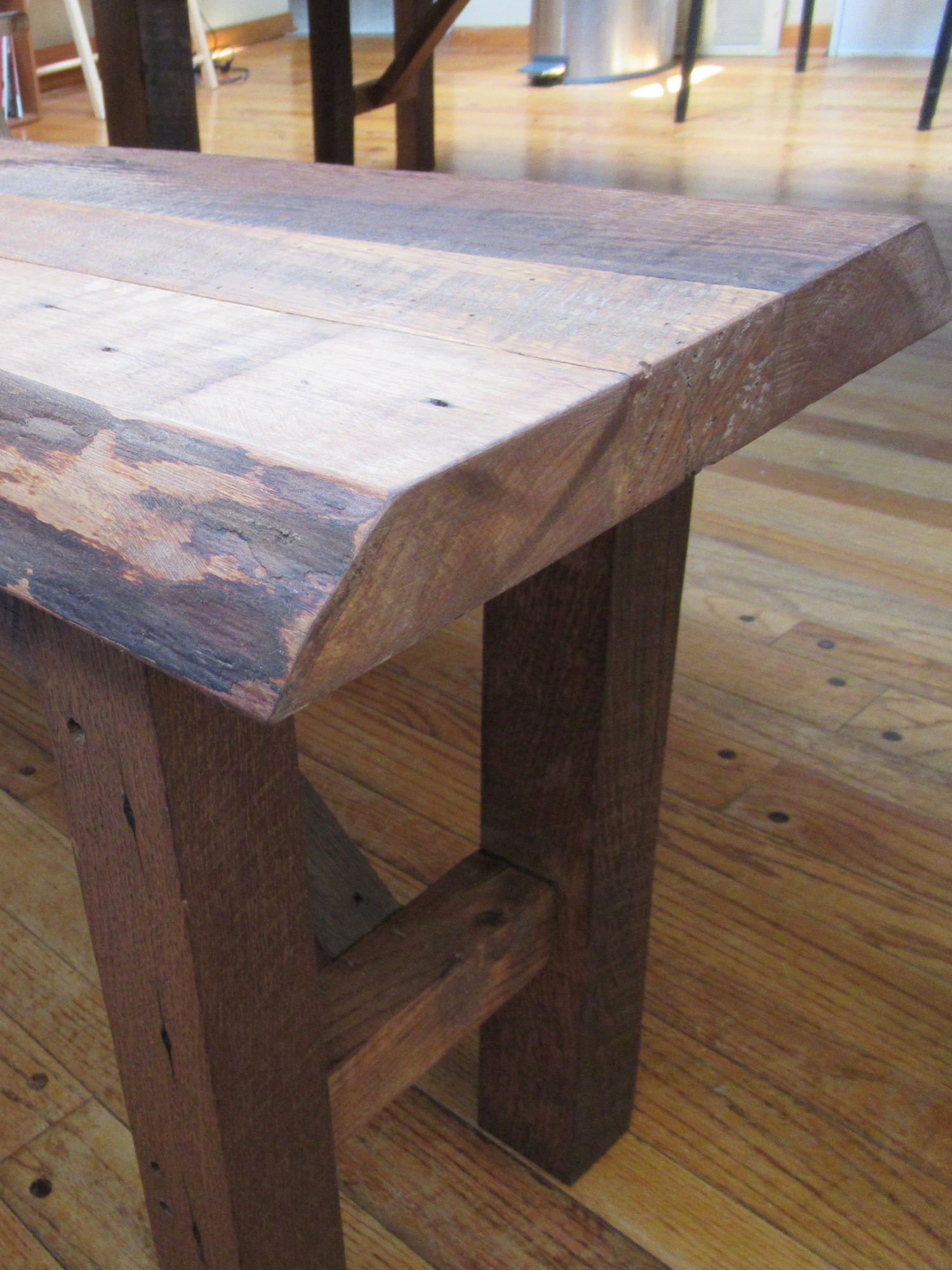 The end of a custom made reclaimed barnwood bench