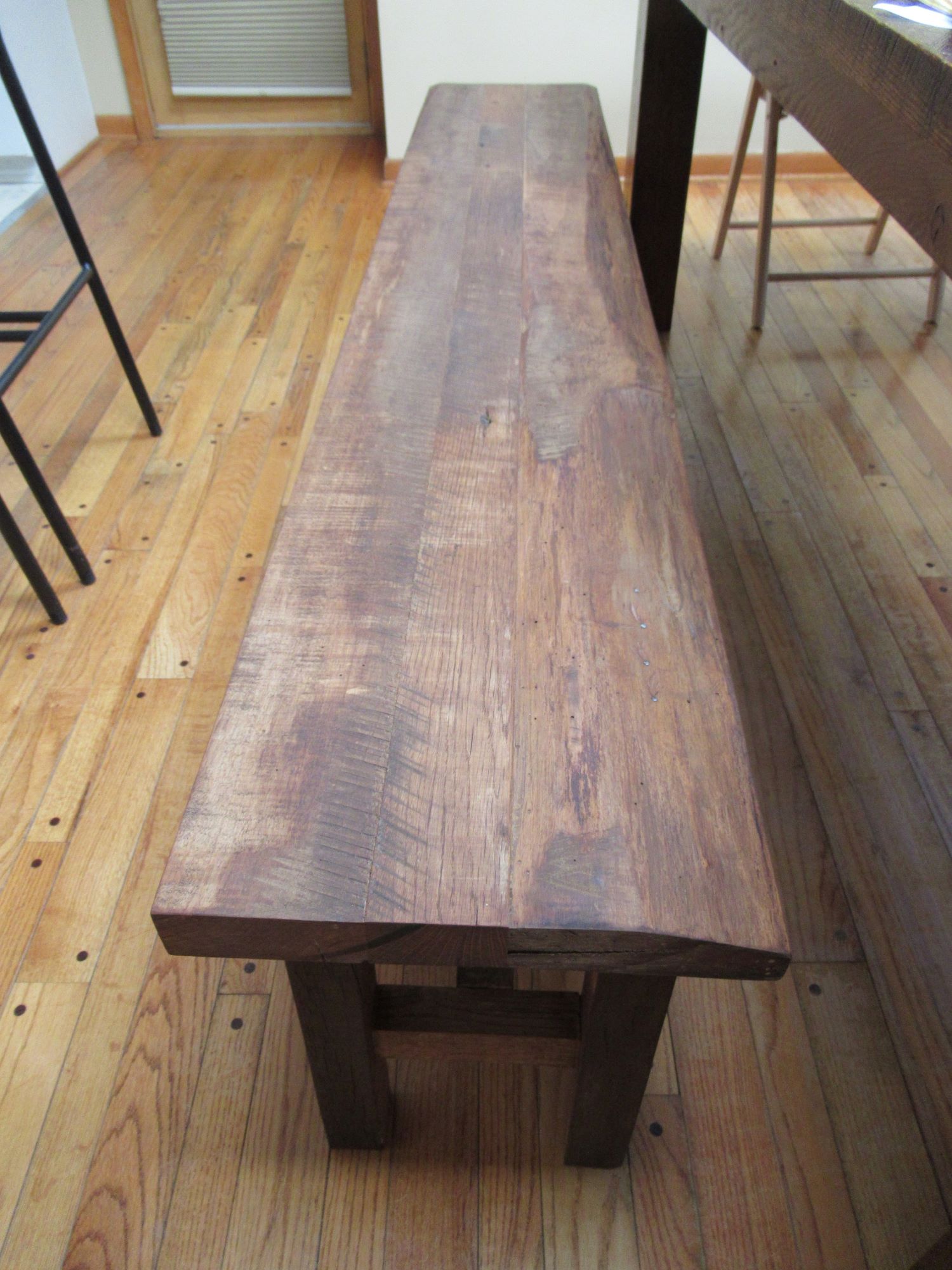 Handcrafted barnwood bench to accompany a custom viking table