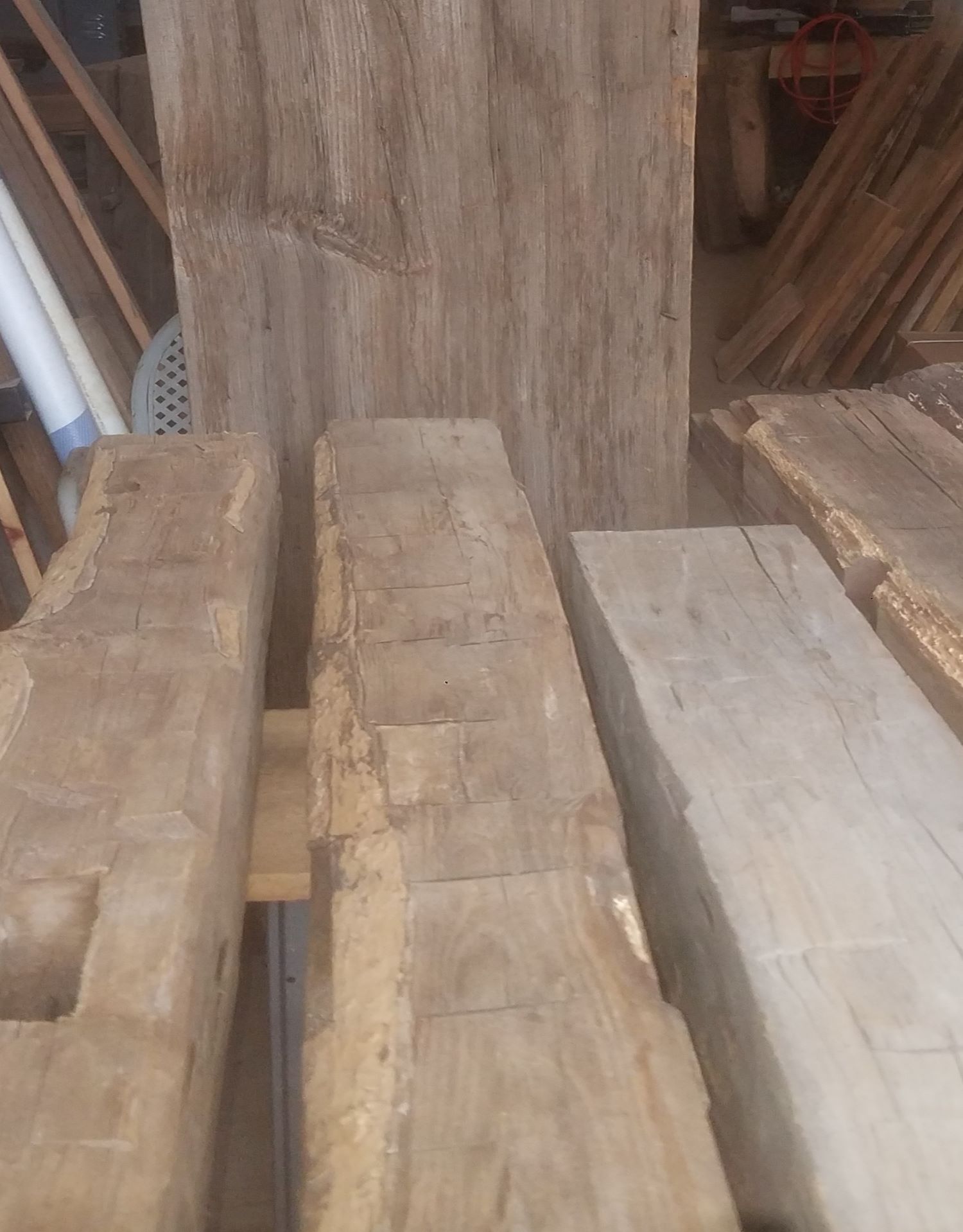 Hand hewn barn beams that will be used as rafters in a customer's home