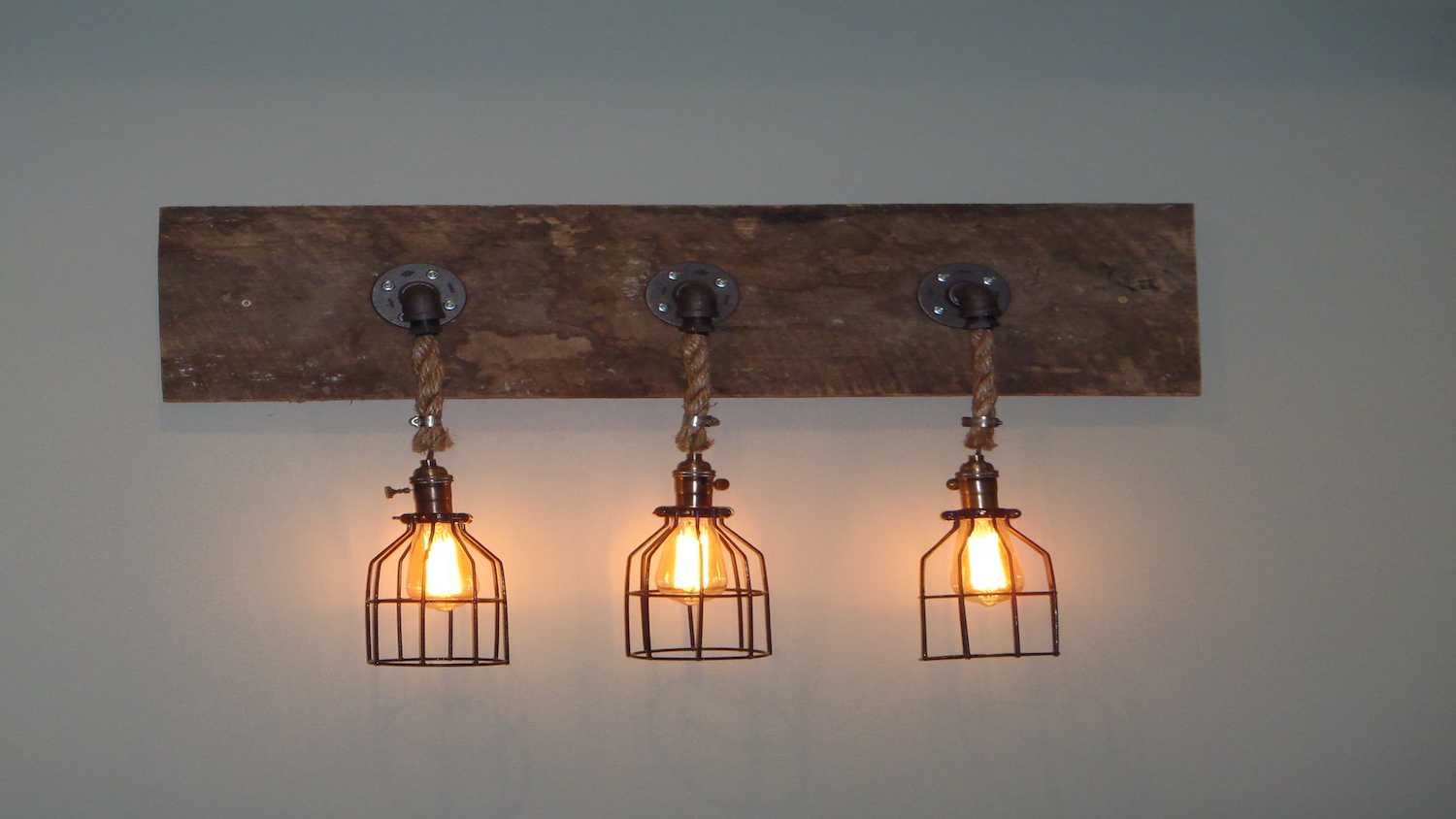 A wall light made using Michigan Reclaimed Barns and Lumber wood