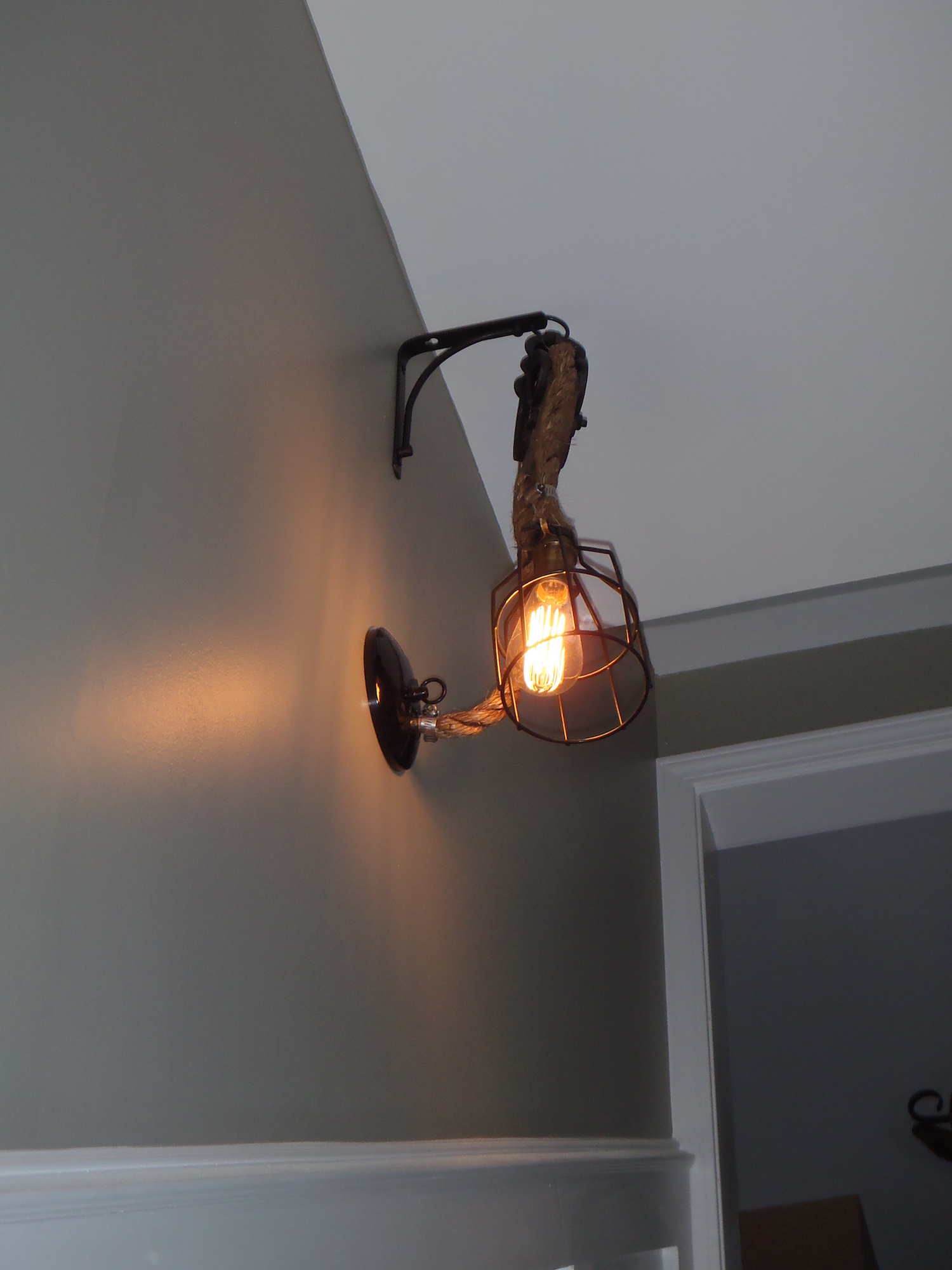 A wall light crafted by a Michigan Reclaimed Barns and Lumber customer
