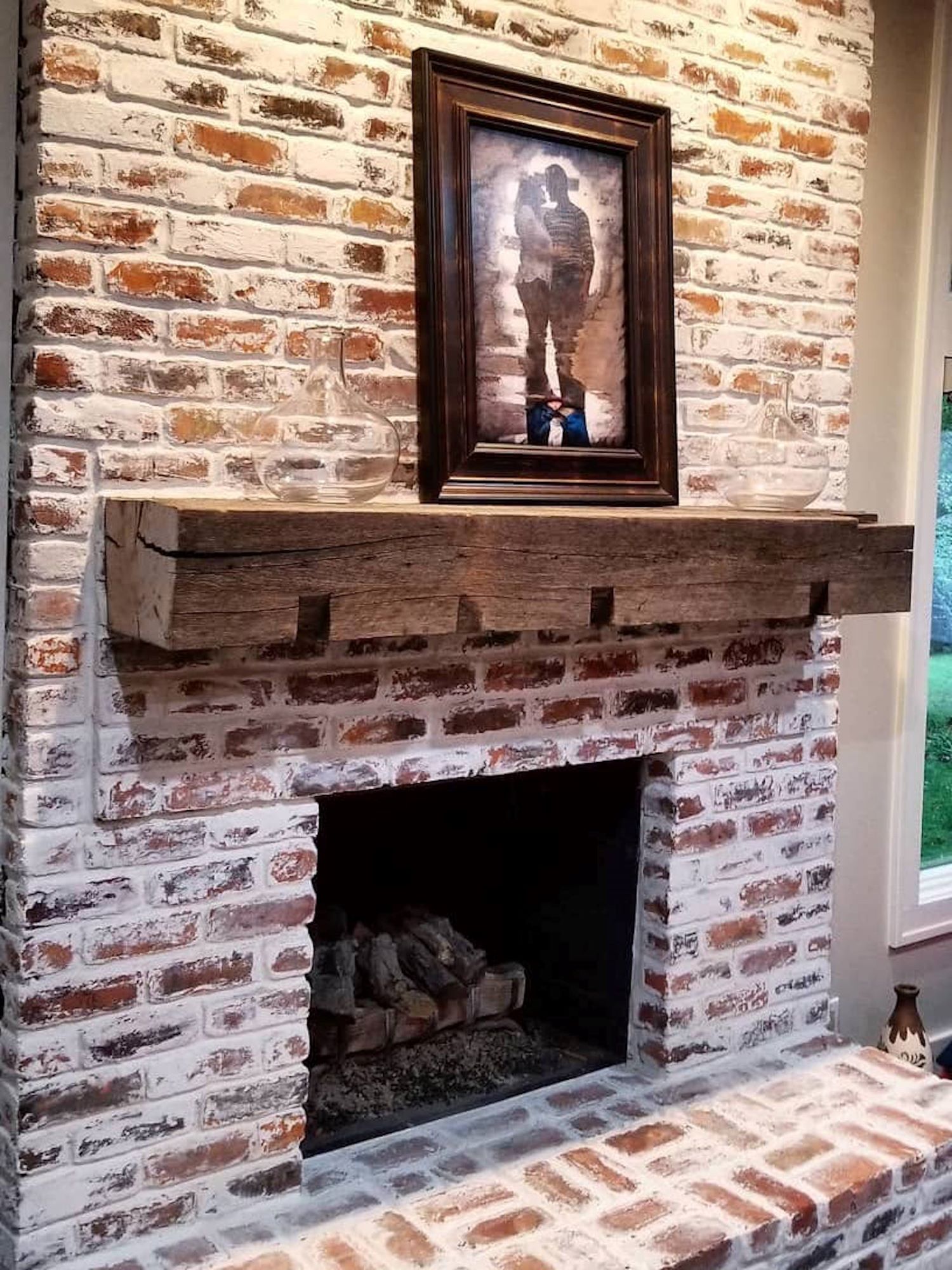Notched barnwood mantle over a fireplace