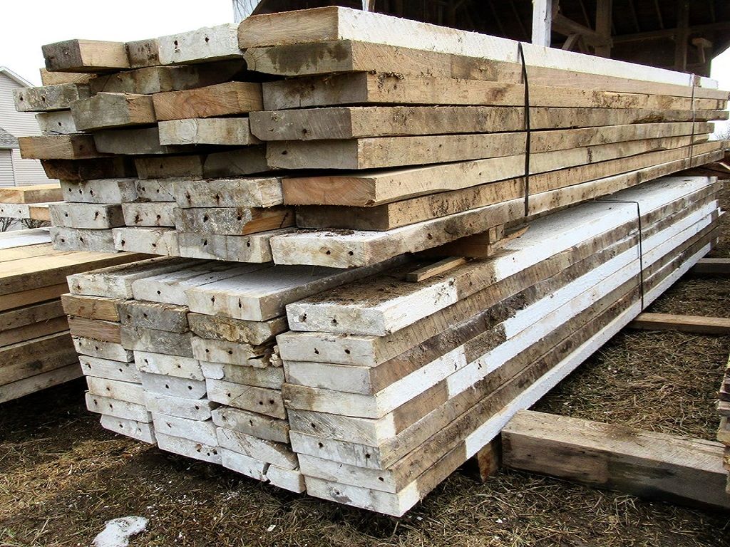 A stack of 2x8 and 2x10 elm reclaimed barnwood floor joists