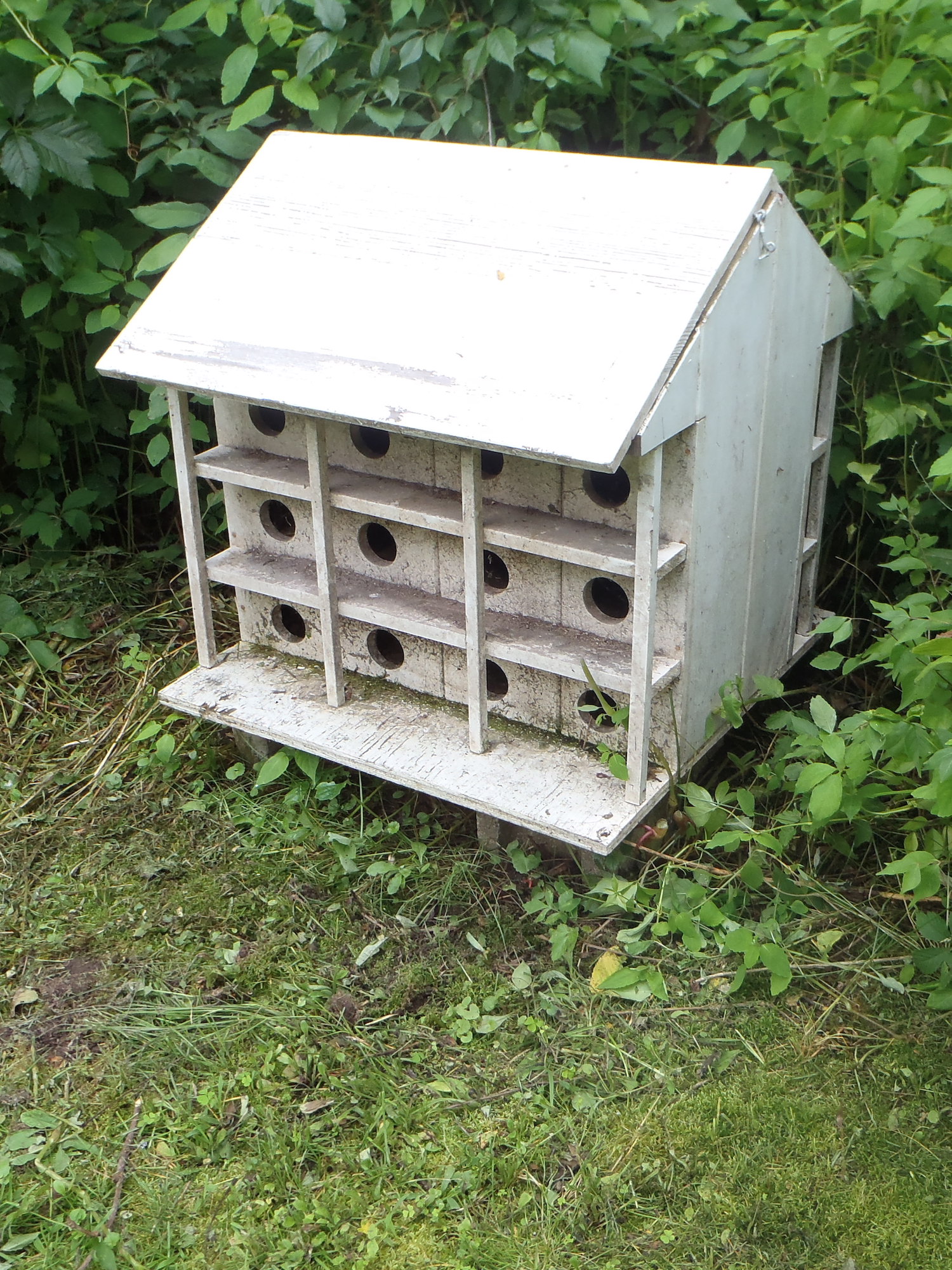 A white birdhouse discovered at a barn deconstruction site