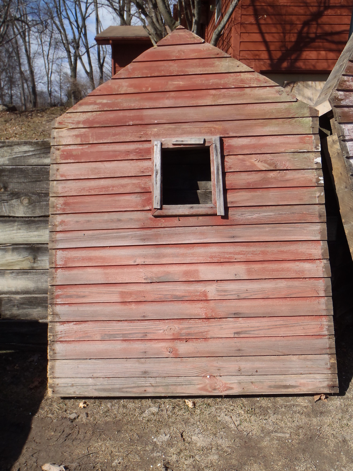 One wall of an outbuilding that was recovered from a barn demolition site